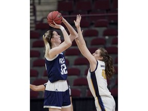 Rice's Nancy Mulkey (32) shoots as Marquette's Lauren Van Kleunen (42) defends during the first half of a first round women's college basketball game in the NCAA Tournament Friday, March 22, 2019, in College Station, Texas.