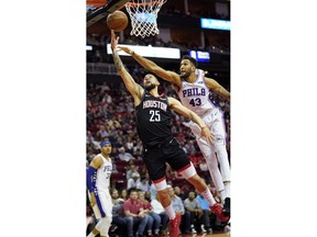 Houston Rockets' Austin Rivers (25) goes up to shoot as Philadelphia 76ers' Jonah Bolden (43) defends during the second half of an NBA basketball game Friday, March 8, 2019, in Houston.