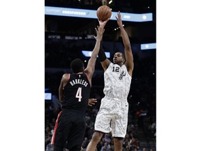 San Antonio Spurs center LaMarcus Aldridge (12) shoots over Portland Trail Blazers forward Maurice Harkless (4) during the first half of an NBA basketball game, in San Antonio, Saturday, March 16, 2019.