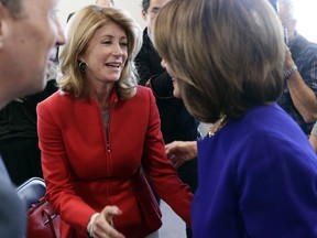 Former state senator Wendy Davis, center, visits with Speaker of the House Nancy Pelosi, D-Calif., right, following a stop for a news conference, Tuesday, March 5, 2019, in Austin, Texas.