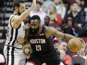 Houston Rockets guard James Harden (13) dribbles as San Antonio Spurs guard Marco Belinelli (18) defends during the first half of an NBA basketball game Friday, March 22, 2019, in Houston.