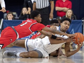 Old Dominion guard Jason Wade, right, competes for a loose ball with Western Kentucky guard Lamonte Bearden (1) during the first half of an NCAA college basketball game for the Conference USA men's tournament championship, Saturday, March 16, 2019, in Frisco, Texas.