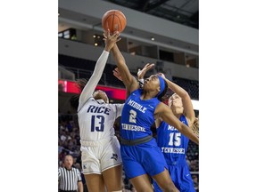 Middle Tennessee guards Taylor Sutton (2) and Anna Jones (15) go up for a rebound against Rice guard Erica Ogwumike (13) in the first half of an NCAA college basketball game in the championship game of the Conference USA women's tournament, Saturday, March 16, 2019, in Frisco, Texas.