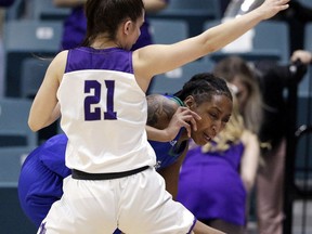 Texas A&M-Corpus Christi guard Dalesia Booth, right, tries to drive around Abilene Christian guard Kayla Galindo (21) during the first half of an NCAA college basketball game for the Southland Conference women's tournament title Sunday, March 17, 2019, in Katy, Texas.