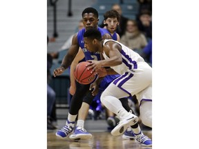 Abilene Christian guard Jaylen Franklin, front, drives around New Orleans guard Troy Green, back, during the first half of an NCAA college basketball game for the Southland Conference men's tournament title Saturday, March 16, 2019, in Katy, Texas.