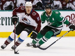 Colorado Avalanche left wing Matt Calvert (11) skates with the puck in front of Dallas Stars center Tyler Seguin (91) during the first period of an NHL hockey game in Dallas, Thursday, March 21, 2019.