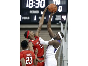 Texas Tech forward Tariq Owens (11) blocks a shot by TCU forward Kouat Noi, right, of Australia in the first half of an NCAA college basketball game in Fort Worth, Texas, Saturday, March 2, 2019.