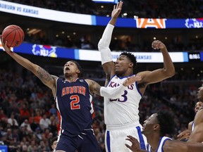 Auburn guard Bryce Brown (2) drives to the basket against Kansas forward David McCormack, right, during a second-round game in the NCAA men's college basketball tournament Saturday, March 23, 2019, in Salt Lake City.