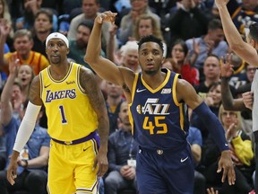 Utah Jazz guard Donovan Mitchell (45) celebrates after scoring 3-pointer against Los Angeles Lakers guard Kentavious Caldwell-Pope (1) during the first half of an NBA basketball game Wednesday, March 27, 2019, in Salt Lake City.