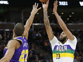 New Orleans Pelicans forward Anthony Davis (23) shoots as Utah Jazz center Rudy Gobert (27) defends in the first half during an NBA basketball game Monday, March 4, 2019, in Salt Lake City.