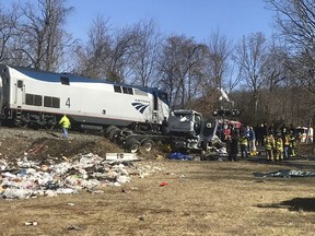 FILE - In this Wednesday, Jan. 31, 2018 file photo, emergency personnel work at the scene of a train crash involving a garbage truck struck by a train carrying Republican congressmen in Crozet, Va. Federal investigators have released nearly 100 documents that detail last year's fatal accident. National Transportation Safety Board spokesman Keith Holloway said the information was made public Tuesday, March 19, 2019 "in anticipation that a final report may be issued soon."