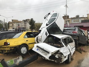 In this photo provided by Mehr News Agency, vehicles are piled up on the street after a flash flood in the southern city of Shiraz, Iran, Monday, March 25, 2019.
