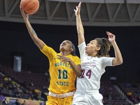 Norfolk State's La'Deja James, left, drives in for a lay-up against Bethune-Cookman's Angel Golden during an NCAA college basketball game in the championship of the Mid-Eastern Athletic Conference tournament, Saturday, March 16, 2019, in Norfolk, Va.