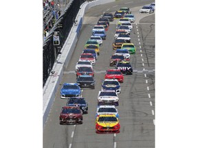 Joey Logano (22) leads the field at the start of a NASCAR Cup Series auto race at the Martinsville Speedway in Martinsville, Va., Sunday, March 24, 2019.