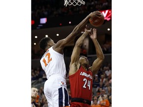 Virginia guard De'Andre Hunter (12) blocks the shot of Louisville forward Dwayne Sutton (24) during the first half of an NCAA college basketball game in Charlottesville, Va., Saturday, March 9, 2019.