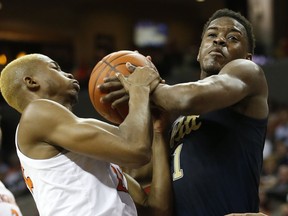 Pittsburgh guard Xavier Johnson, right, fights for a rebound with Virginia forward Mamadi Diakite, left, during the first half of an NCAA college basketball game in Charlottesville, Va., Saturday, March 2, 2019.