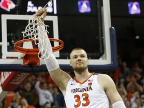 Virginia center Jack Salt (33) holds the net after a victory over Louisville after an NCAA college basketball game in Charlottesville, Va., Saturday, March 9, 2019.