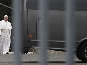 Pope Francis arrives to board a bus as he leaves for a week of spiritual exercises in the village of Ariccia, at the Vatican, Sunday March 10, 2019.