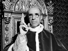In this file photo dated Sept. 1945, Pope Pius XII, wearing the ring of St. Peter, raises his right hand in a papal blessing at the Vatican. Pope Francis said Monday, March 4, 2019 he has decided to open up to researchers the Vatican archives on Second World War-era Pope Pius XII, who has been accused by Jews of staying silent on the Holocaust.