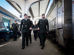 Members of the Canadian Forces carry a pair of combat boots to a VIA Rail train to begin their journey to Halifax, at Pacific Central Station in Vancouver, on Friday March 29, 2019. The boots will travel across the country on the train to symbolize those who travelled to Halifax during the Second World War before they embarked for Europe. The journey is part of the federal government's plan to commemorate the 7th anniversary of D-Day and the Battle of Normandy.