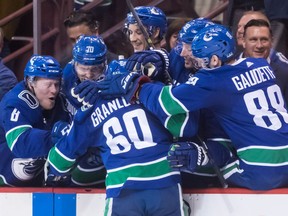 Vancouver Canucks' Markus Granlund (60), of Finland, Brock Boeser, back from left to right, Tanner Pearson, Jay Beagle, Tim Schaller and Adam Gaudette celebrate Granlund's shootout goal against the Dallas Stars in NHL hockey action in Vancouver, on Saturday March 30, 2019.