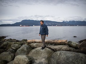 Dr. Andrew Trites, a professor and director of the Marine Mammal Research Unit at the University of British Columbia, walks across rocks at Spanish Banks Beach after posing for a photograph, in Vancouver, on Friday March 15, 2019. A marine mammal scientist in Vancouver says he thinks his work has been misrepresented online and he's worried it's part of a trend that has he and his colleagues questioning whether they should talk to media at all in the era of "fake news."