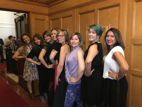 Bhinder Sajan, right to left, Shannon Waters, Liza Yuzda, Justine Hunter, Jen Holmwood, Katie DeRosa, Tanya Fletcher and Kylie Stanton pose for a photo at the B.C. Legislature in Victoria on Thursday, March 28, 2019. A dress code debate at British Columbia's legislature has prompted some women staff and journalists to roll up their sleeves in protest.