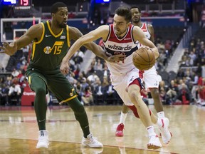 Washington Wizards guard Tomas Satoransky (31), from the Czech Republic, works to get past Utah Jazz forward Derrick Favors (15) during the first half of an NBA basketball game Monday, March 18, 2019, in Washington.