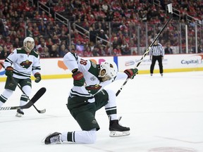 Minnesota Wild left wing Jordan Greenway (18) celebrates his goal during the first period of the team's NHL hockey game against the Washington Capitals, Friday, March 22, 2019, in Washington. At left is Wild defenseman Brad Hunt.