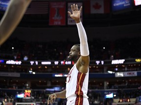 Miami Heat guard Dwyane Wade (3) acknowledges the crowd during the first half of an NBA basketball game against the Washington Wizards, Saturday, March 23, 2019, in Washington.