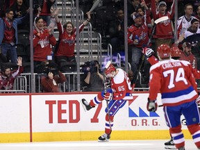 Washington Capitals left wing Andre Burakovsky (65) celebrates his goal during the first period of the team's NHL hockey game against the New Jersey Devils, Friday, March 8, 2019, in Washington. At right is Capitals defenseman John Carlson.