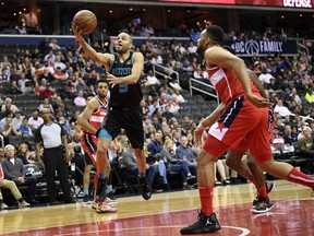 Charlotte Hornets guard Tony Parker (9) goes to the basket against Washington Wizards forward Jabari Parker, right, during the first half of an NBA basketball game, Friday, March 15, 2019, in Washington.