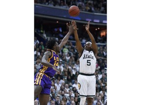 Michigan State guard Cassius Winston shoots over LSU forward Emmitt Williams (24) during the first half of an East Regional semifinal in the NCAA men's college basketball tournament Friday, March 29, 2019, in Washington.