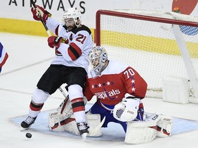 Washington Capitals goaltender Braden Holtby (70) battles for the puck against New Jersey Devils right wing Kyle Palmieri (21) during the third period of an NHL hockey game Friday, March 8, 2019, in Washington. The Capitals won 3-0.