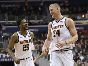 Denver Nuggets guard Malik Beasley (25) and Mason Plumlee (24) smile after Beasley made a 3-point basket during the second half of the team's NBA basketball game against the Washington Wizards, Thursday, March 21, 2019, in Washington. The Nuggets won 113-108.