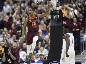Virginia Tech guard Ahmed Hill (13) celebrates after scoring, next to Duke forward Zion Williamson (1) during the first half of an NCAA men's college basketball tournament East Region semifinal in Washington, Friday, March 29, 2019.