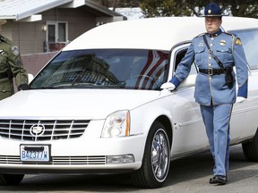 A hearse bearing the body of Kittitas County Deputy Sheriff Ryan Thompson arrives ahead of a memorial service at Central Washington University, Thursday, March 28, 2019, in Ellensburg, Wash. Hundreds of law enforcement officers from throughout the region have gathered for a memorial service for Thompson, who was shot to death by a road rage suspect last week.