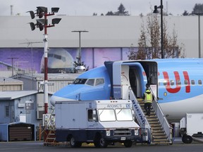 A worker walks up steps to the right of an avionics truck parked next to a Boeing 737 MAX 8 airplane being built for TUI Group at Boeing Co.'s Renton Assembly Plant Wednesday, March 13, 2019, in Renton, Wash. President Donald Trump says the U.S. is issuing an emergency order grounding all Boeing 737 Max 8 and Max 9 aircraft in the wake of a crash of an Ethiopian Airliner.