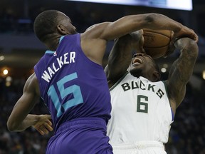Milwaukee Bucks' Eric Bledsoe is fouled by Charlotte Hornets' Kemba Walker during the second half of an NBA basketball game Saturday, March 9, 2019, in Milwaukee. The Bucks won, 131-114.