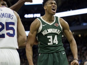 Milwaukee Bucks' Giannis Antetokounmpo reacts after making a shot during the second half of the team's NBA basketball game against the Philadelphia 76ers on Sunday, March 17, 2019, in Milwaukee. The 76ers won 130-125.