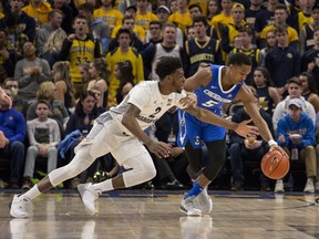 Creighton guard Ty-Shon Alexander, right, defends against Marquette forward Sacar Anim, left, during the first half of an NCAA college basketball game Sunday, March 3, 2019, in Milwaukee.