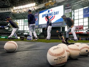 Milwaukee Brewers players warm up before an Opening Day baseball game against the St. Louis Cardinals Thursday, March 28, 2019, in Milwaukee.