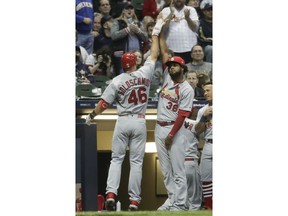 St. Louis Cardinals' Paul Goldschmidt is congratulated by Jose Martinez after hitting a two-run home run during the first inning of a baseball game against the Milwaukee Brewers Friday, March 29, 2019, in Milwaukee.