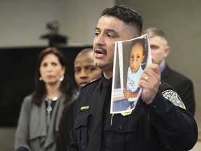 In this Friday, March 15, 2019, photo, Milwaukee Police Chief Alfonso Morales holds a photo of 2-year-old Noelani Robinson as he speaks at a news conference at the Police Administration Building in Milwaukee. A child's body found wrapped in a blanket along a Minnesota highway is believed to be that of Noelani, a missing 2-year-old girl whose mom police have said was fatally shot by her former pimp, authorities announced Saturday.