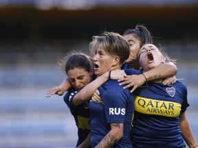 Boca Juniors' Yamila Rodriguez, center, celebrates with teammates after scoring in the Superliga women's soccer tournament in Buenos Aires, Argentina, on Saturday, March 9, 2019. The women competed in one of Argentina's most famous stadiums on Saturday, a milestone for the female players who are fighting for the same rights as male soccer players in the country's most popular sport.