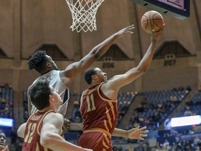Iowa State guard Talen Horton-Tucker (11) goes to the basket while being defended by West Virginia forward Derek Culver (1) during the second half of an NCAA college basketball game Wednesday, March 6, 2019, in Morgantown, W.Va.