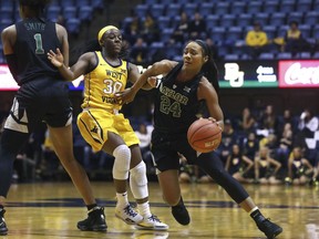 Baylor guard Chloe Jackson (24) drives while defended by West Virginia guard Madisen Smith (30) during the first half of an NCAA college basketball game Monday, March 4, 2019, in Morgantown, W.Va.