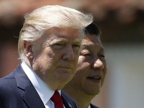 FILE - In this April 7, 2017, file photo, U.S. President Donald Trump, left, and Chinese President Xi Jinping walk together at Mar-a-Lago in Palm Beach, Fla. Foreign leaders showered President Donald Trump and his family with more than $140,000 in gifts during their first year in the White House, with China and Saudi Arabia among the most lavish givers. China's president gave Trump and his wife the two most expensive gifts in 2017: a $14,400 calligraphy display and a $16,250 dinnerware set featuring Trump's Mar-a-Lago resort. All gifts were turned over to the National Archives.
