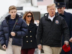 FILE - In this March 8, 2019 file photo, President Donald Trump and first lady Melania Trump and their son Barron Trump, walk from Marine One to board Air Force One, Friday, March 8, 2019, in Andrews Air Force Base, Md. The White House has a teenager as a resident once again. President Donald Trump's youngest child, Barron, turned 13 on Wednesday. Barron and his mother, Melania Trump, are spending the break at their home in Palm Beach, Florida. The president was in Washington with plans for a day trip to Ohio.