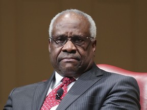 FILE - In this Feb. 15, 2018, file photo, Supreme Court Associate Justice Clarence Thomas sits as he is introduced during an event at the Library of Congress in Washington. Thomas is asking his first questions at Supreme Court arguments in more than three years. Arguments were almost over Wednesday in a case about racial discrimination in the South when the court's only African-American member and lone Southerner piped up.